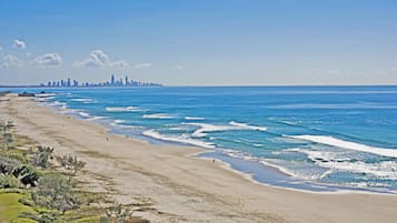 On the beach, white sand, beach umbrellas, beach towels