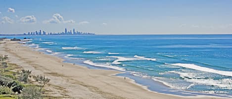 On the beach, white sand, beach umbrellas, beach towels