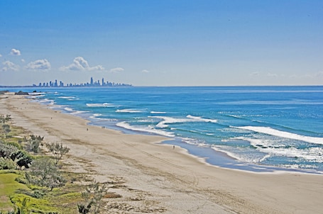 On the beach, white sand, beach umbrellas, beach towels