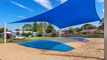 Relax in a shaded outdoor space under a covered area with a curved surface.
