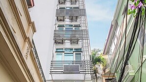 A multi-story building with a sign reading "A25 YOUR HOME" and a staircase leading to the entrance. - A25 Hotel - Doi Can 2 (Hanoi)