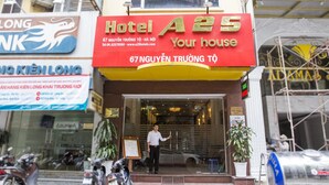 A hotel entrance with a red sign reading "Hotel A25 Your house" and "67 Nguyen Truong Toh".