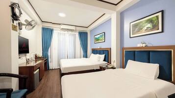 Deluxe Suite Triple Room | Minibar, in-room safe, blackout drapes, iron/ironing board