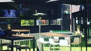 An indoor recreational area with pool tables, chairs, and a billiards table. - The Premier Hotel (Broadmeadow)