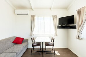 Couples Cabin | Living area | Flat-screen TV, DVD player - Kennett River Family Caravan Park (Kennett River)