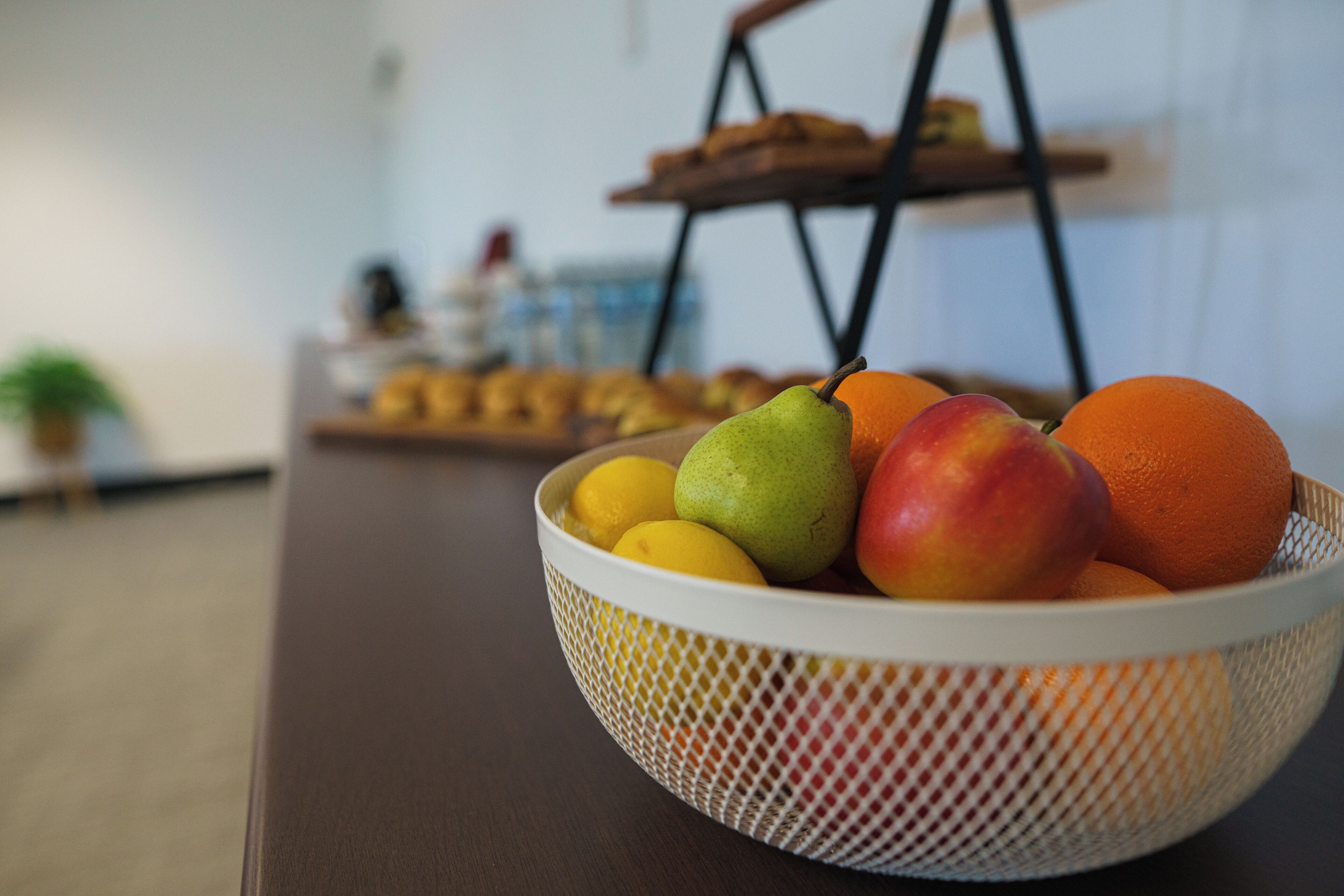 A fruit bowl on a table with a blurred background.