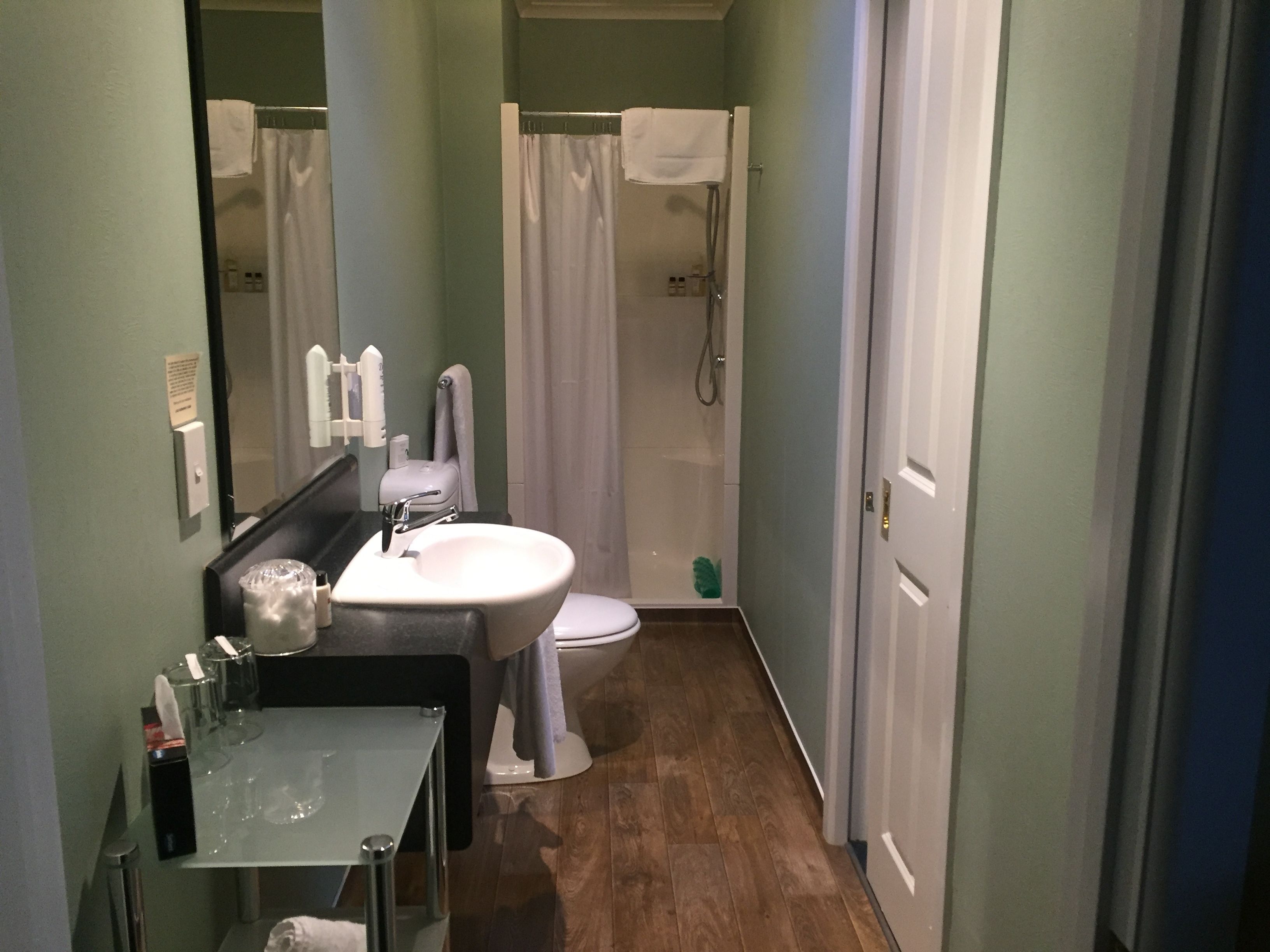 A bathroom with a sink, toilet, and shower.
