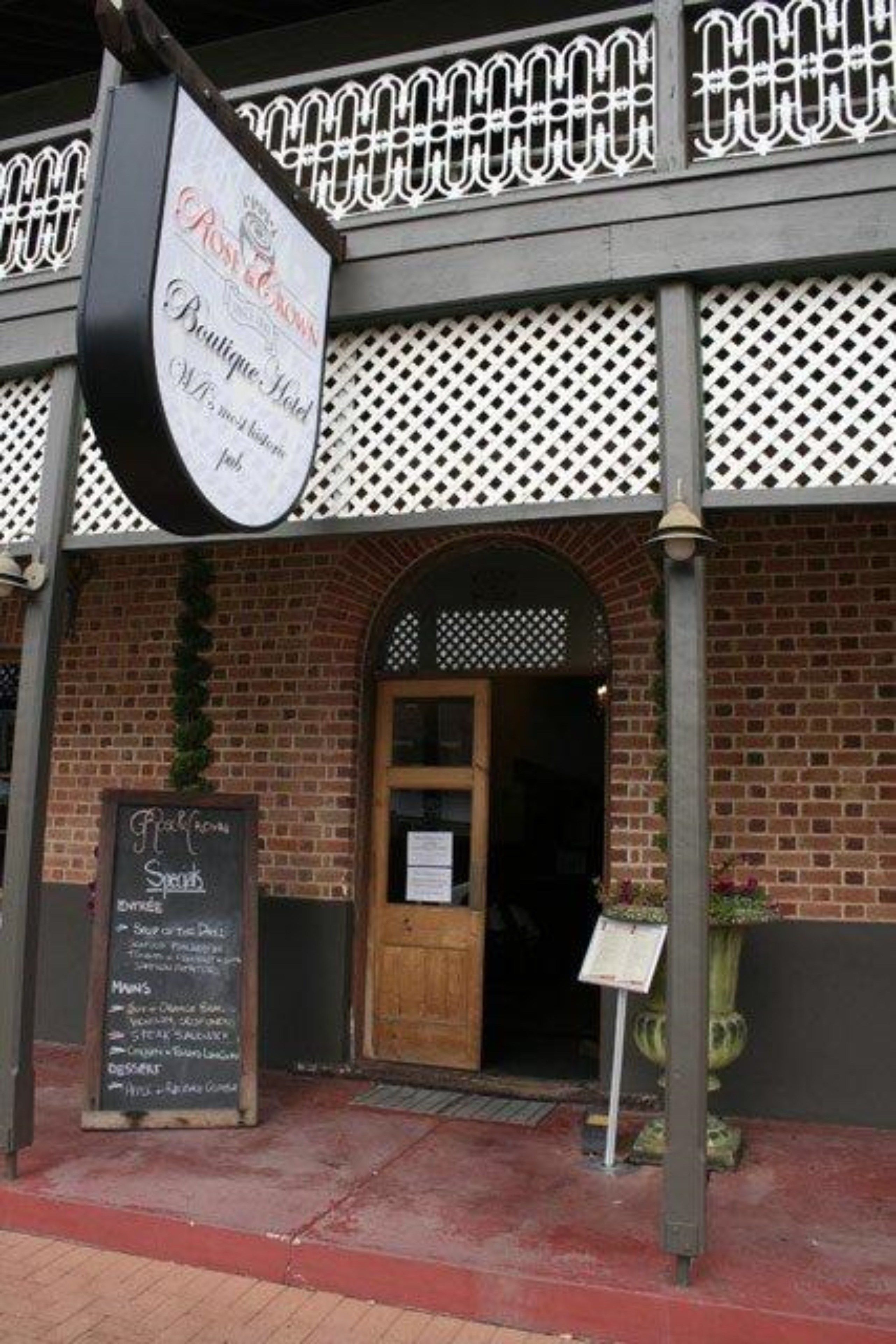 A brick building with a sign for 'Post & Grill' above the entrance.