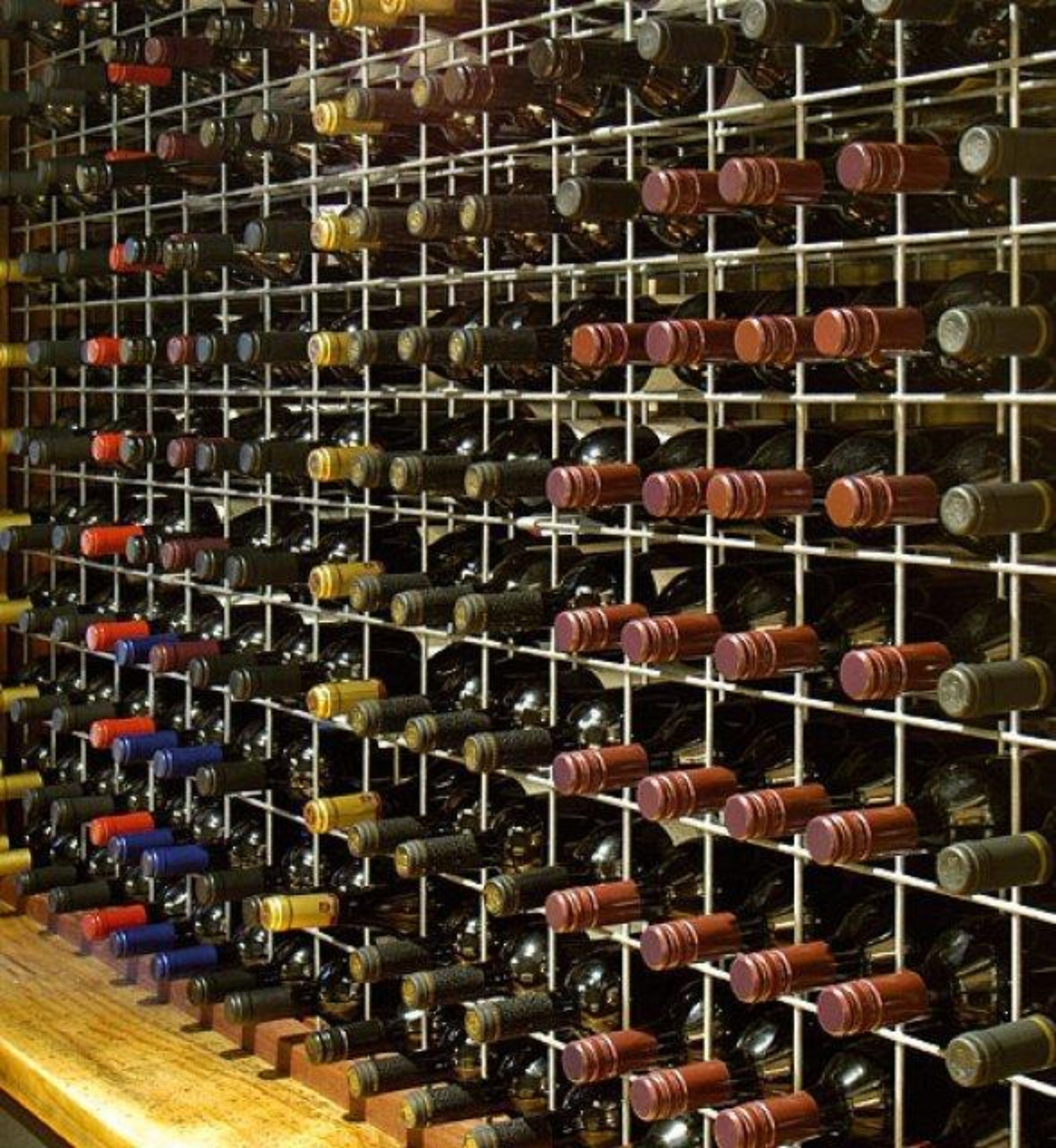 A wine cellar with rows of wine bottles on shelves.