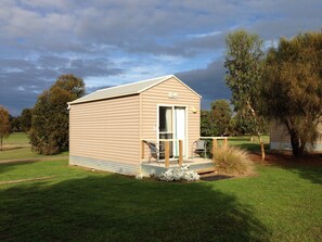 A small, single-story building with a flat roof and a covered porch. - Kangaroo Island Cabins (Kingscote)