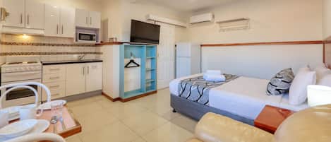 Executive One Bedroom Apartment | Premium bedding, desk, laptop workspace, iron/ironing board