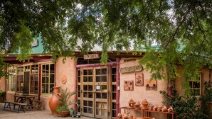 A rustic shop with a reception area, open shop sign, and various pottery items displayed outside. - Barkala Farmstay (Dandry)