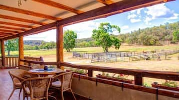 Relax in a serene outdoor space with a view of the surrounding pasture and trees.