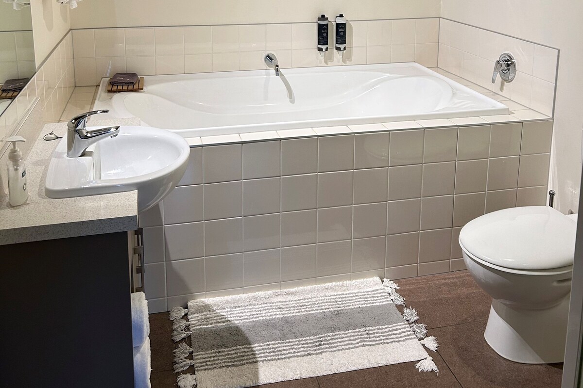 A bathroom with a bathtub, a sink, and a toilet.
