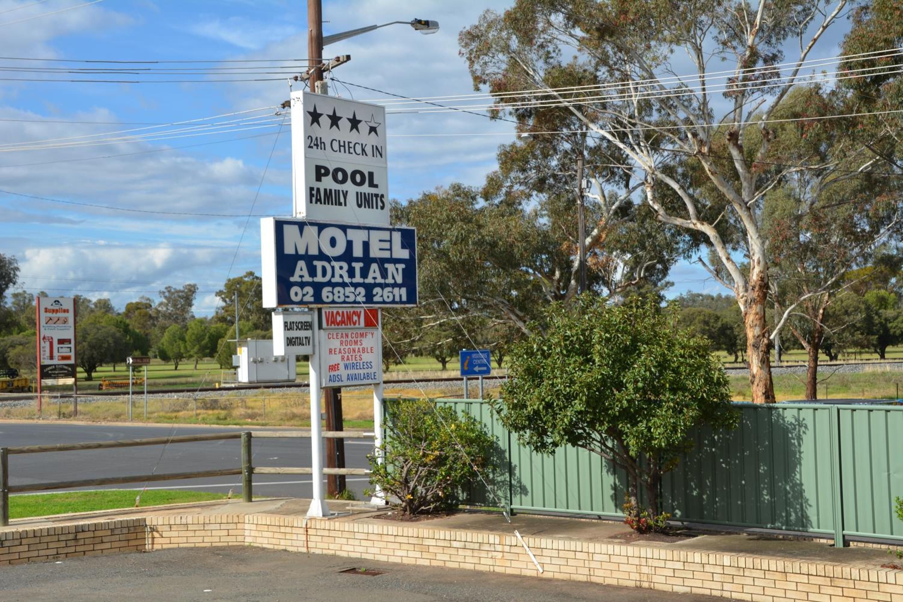A motel named Adrian with a 24-hour check-in, pool, and family units.