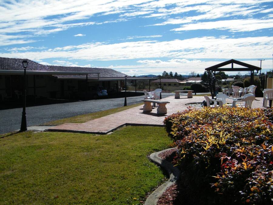A patio area with outdoor seating, a covered seating area, and a well-maintained lawn.