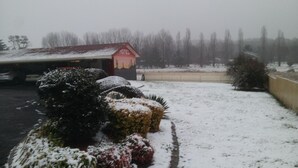 Schneebedeckte Landschaft mit einem Motel im Hintergrund.