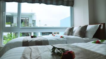 Deluxe Triple Room | Living room | 32-inch LCD TV with cable channels, TV