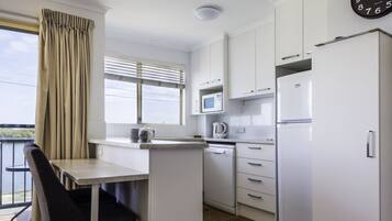 Full-size fridge, microwave, stovetop, coffee/tea maker