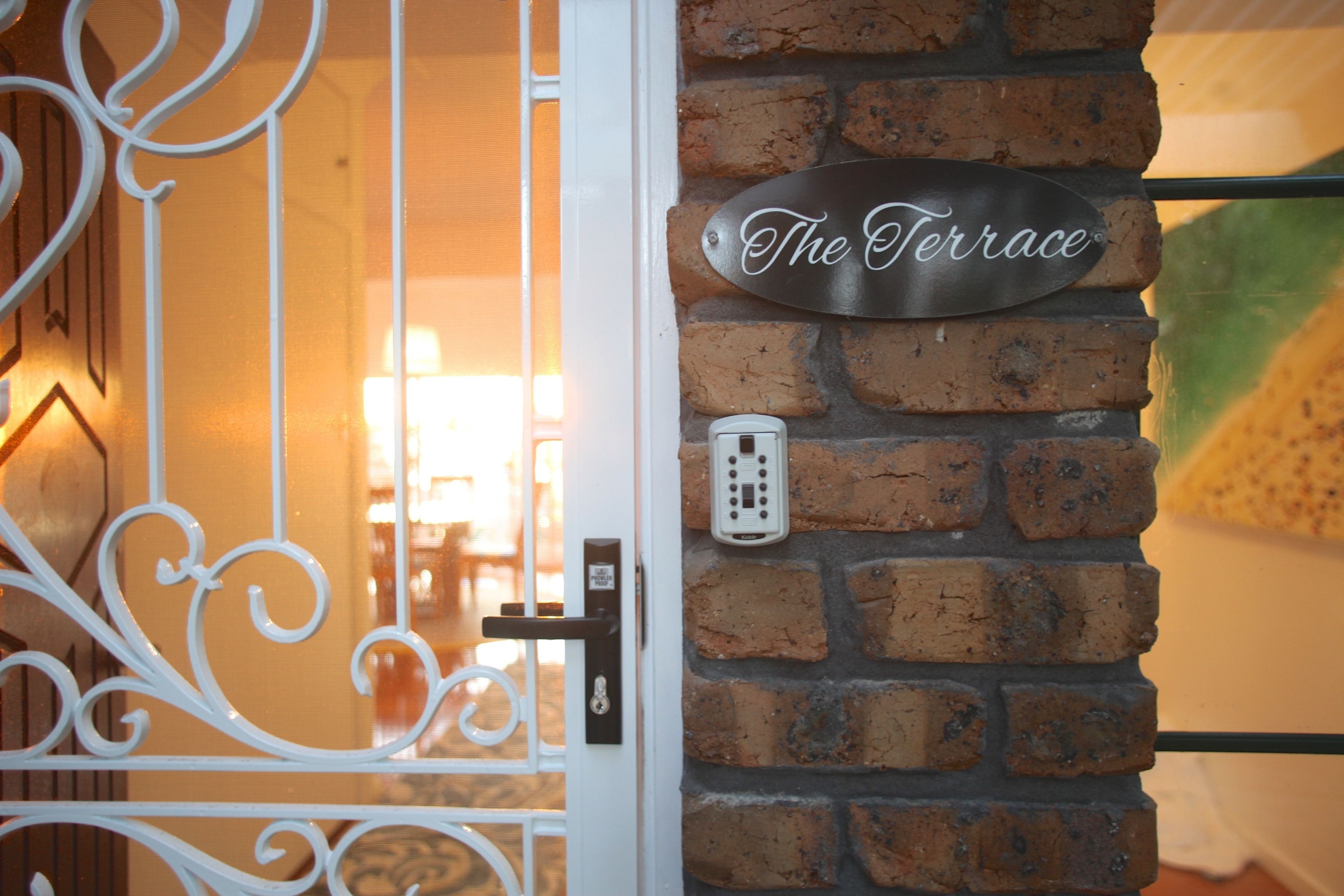 A metal plaque on a brick wall with the inscription "The Terrace."
