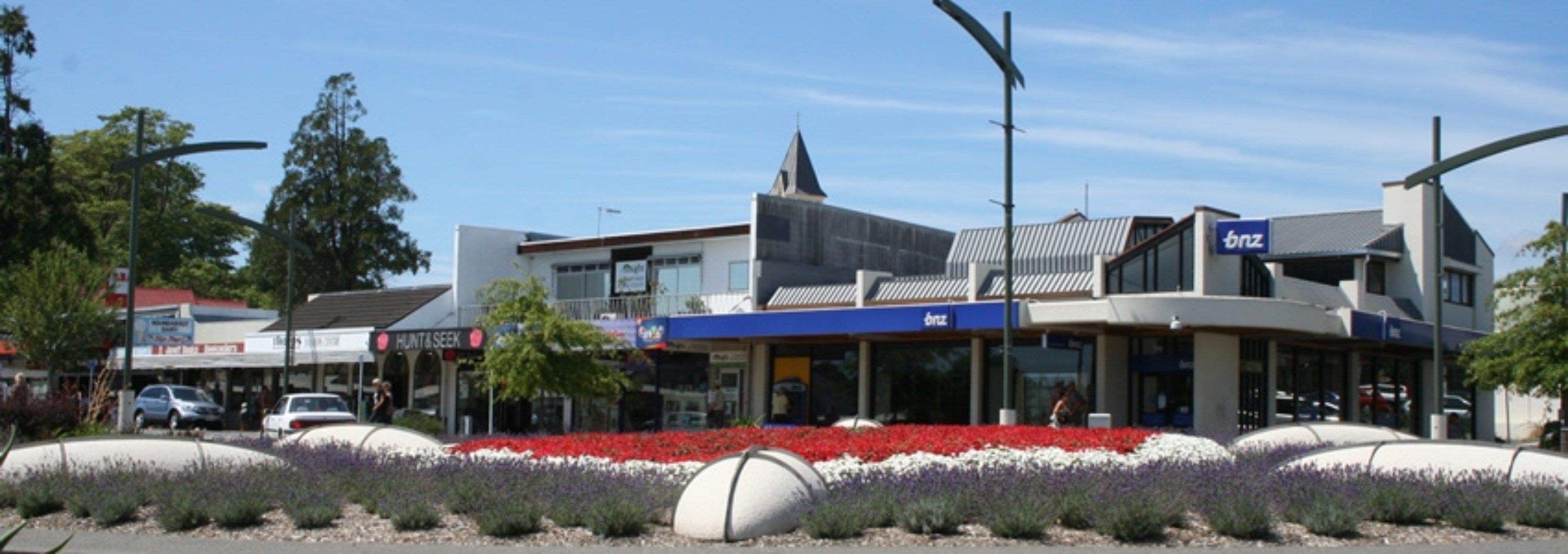 A commercial building with a modern architectural design, featuring a mix of retail and office spaces.