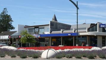 A commercial building with a modern architectural design, featuring a mix of retail and office spaces.