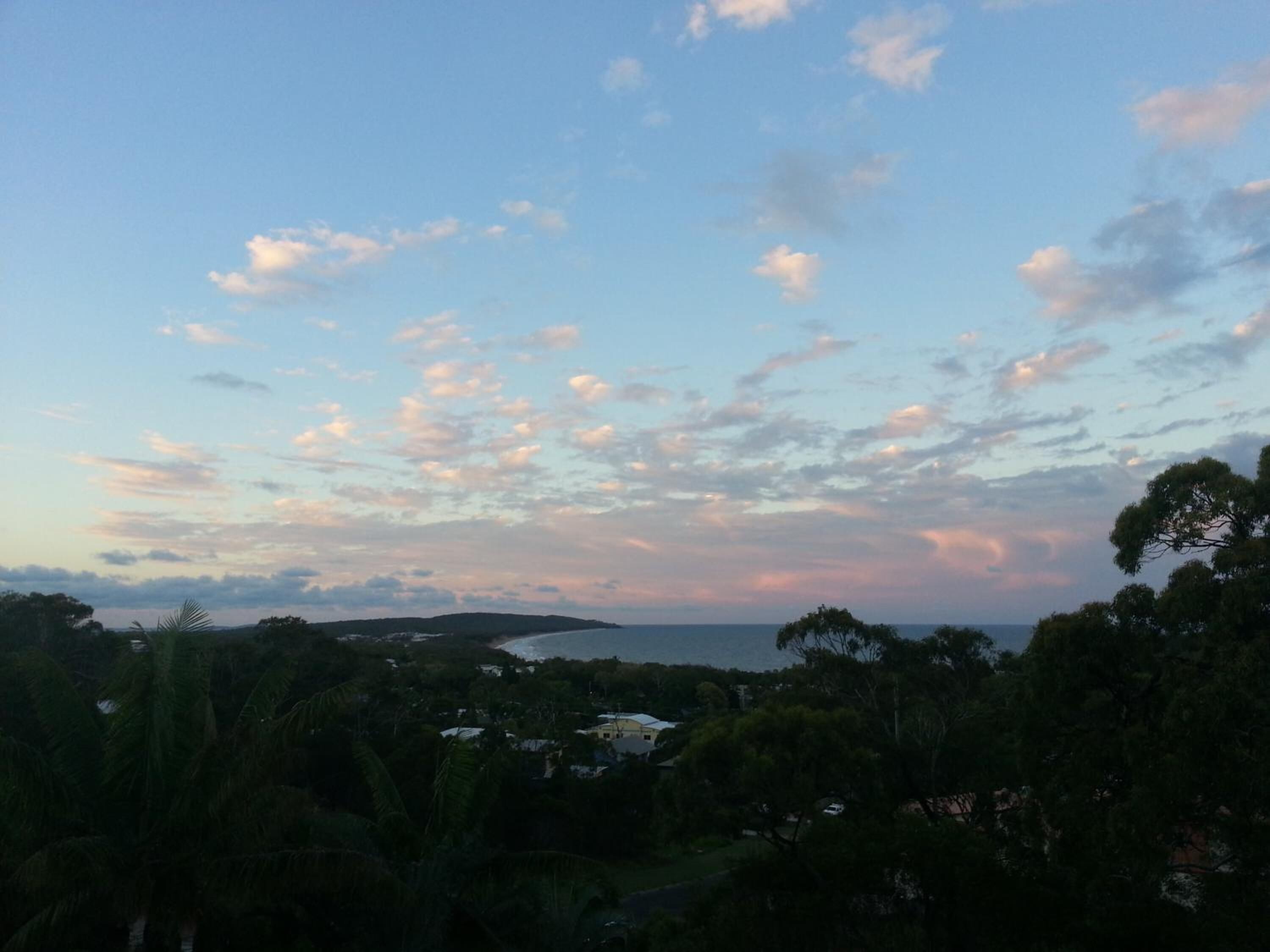 A coastal landscape with a view of the sea and a distant island.