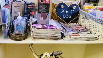 A desk with a map, a heart-shaped box labeled "KEY BOX", and various items including a bicycle.