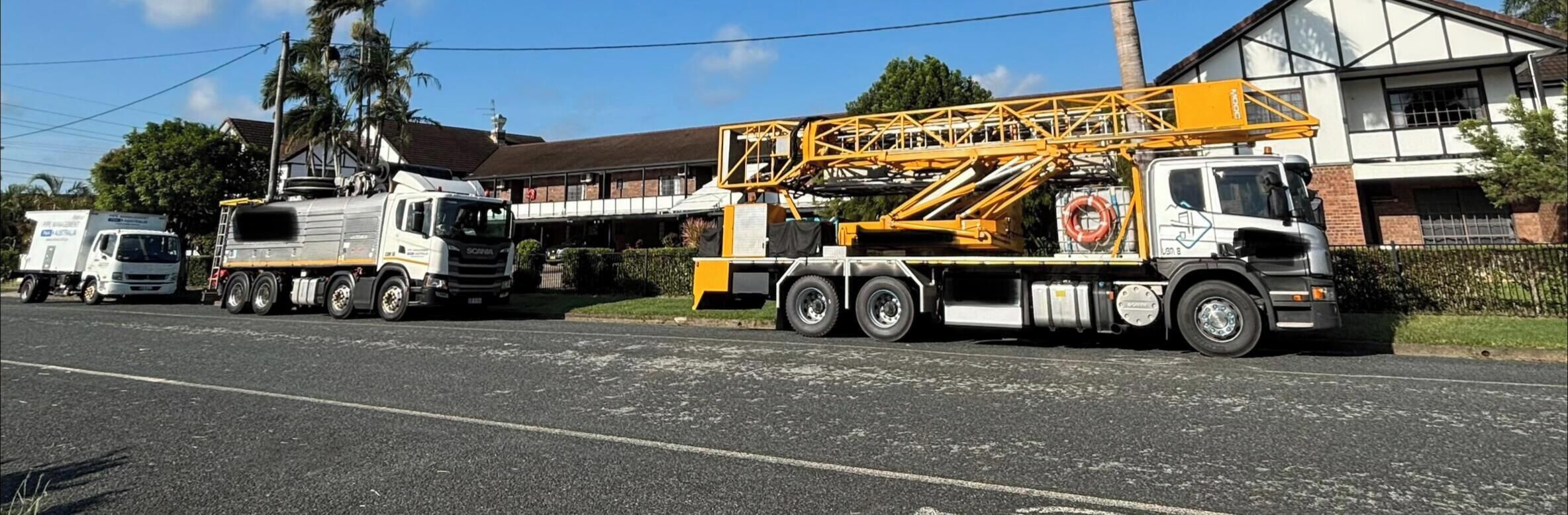A road with a large truck and a crane.