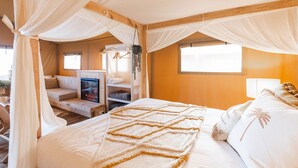 A bedroom with a bed, a sofa, a fireplace, and a window. - NRMA Phillip Island Beachfront Holiday Park (Cowes)