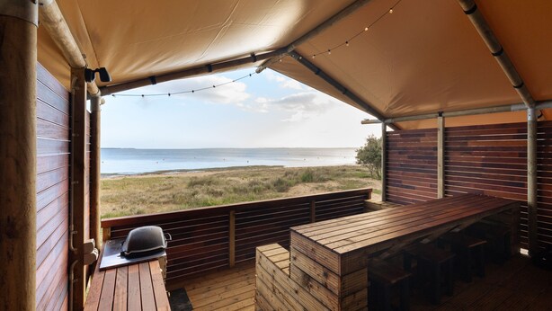 A covered outdoor seating area with a view of the beach and ocean. - NRMA Phillip Island Beachfront Holiday Park (Cowes)
