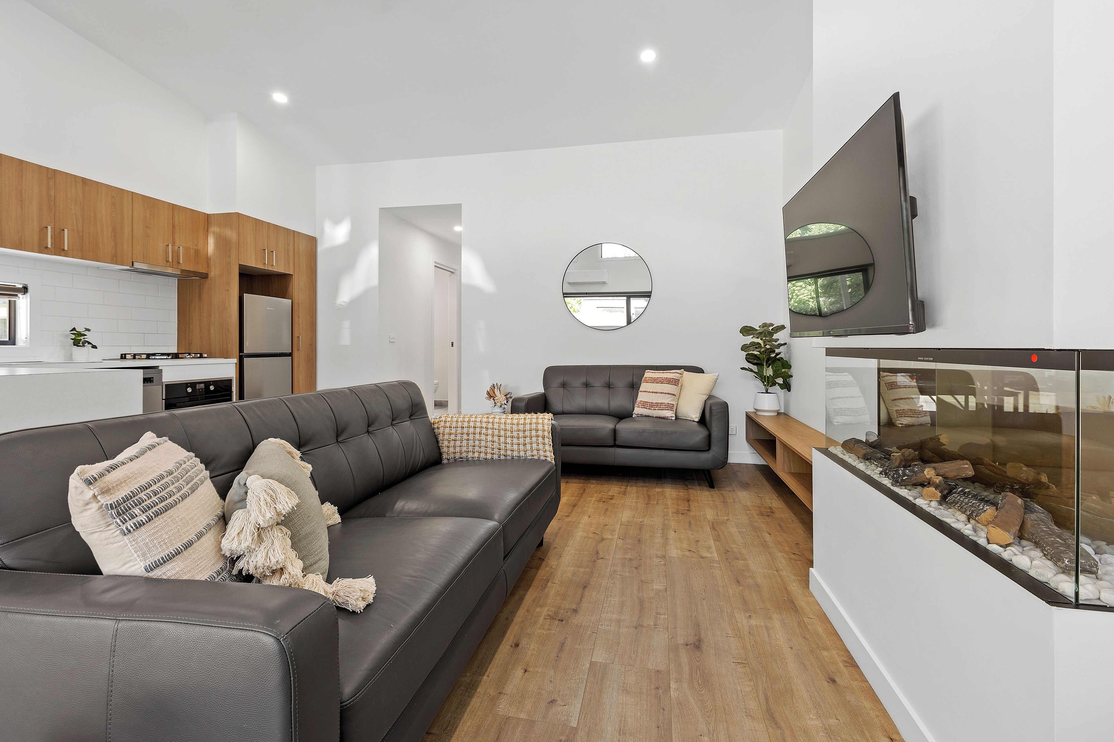 Una sala de estar moderna con un sofá, una mesa de centro y una chimenea.