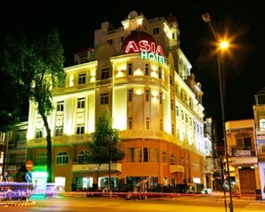 A multi-story building with the signage "ASIA HOTEL" prominently displayed.