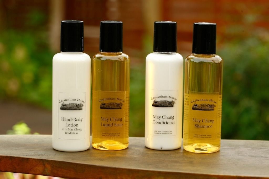 Four bottles of Cheltenham House products: Hand/Body Lotion, May Chang Liquid Soap, May Chang Conditioner, and May Chang Shampoo.