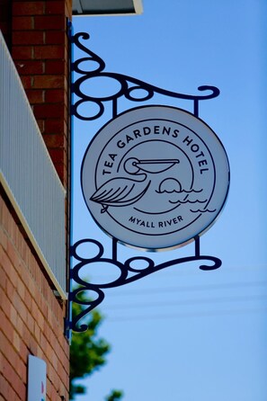 A sign for Tea Gardens Hotel with a bird and waves design, located at Myall River. - Tea Gardens Hotel (Tea Gardens)