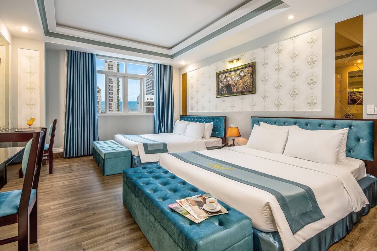 Family Room, Sea View | Minibar, in-room safe, desk, laptop workspace