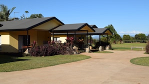 A two-story house with a covered porch and a driveway leading to the entrance. - Atherton Holiday Park (Atherton)