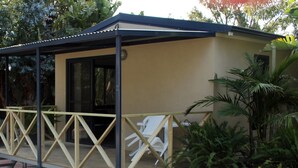 A small, single-story building with a covered porch and a glass door. - Acclaim Kingsway Tourist Park (Madeley)