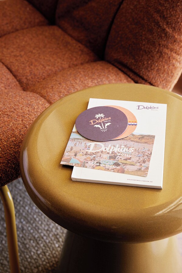 A brochure for Dolphins Motel with a beach scene. - Dolphins Motel (Mollymook)