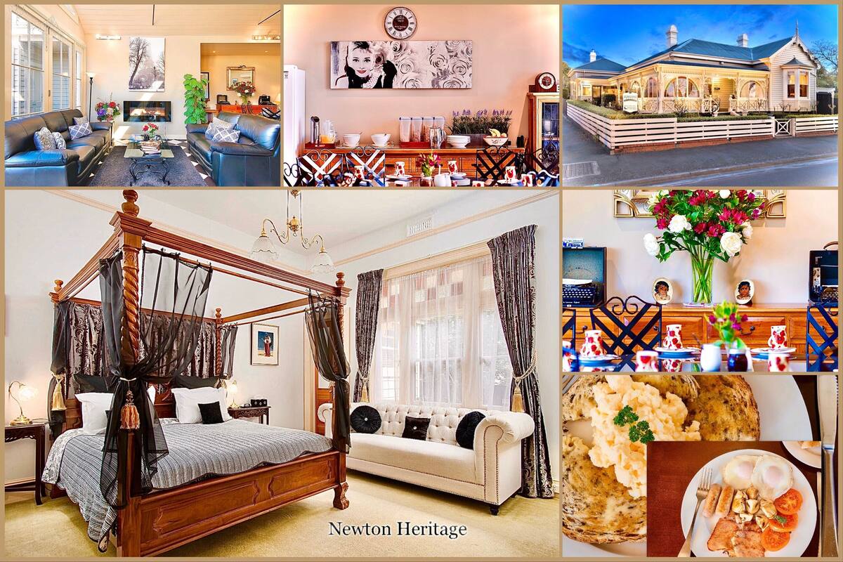 A hotel interior with a living room, dining area, bedroom, and a view of the exterior.