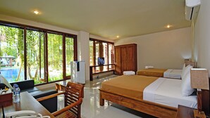 Ein Hotelzimmer mit Bett, Schreibtisch, Stuhl und großen Fenstern.