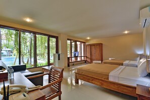 A hotel room with a large window, a desk with a telephone, a chair, two beds, and a television.