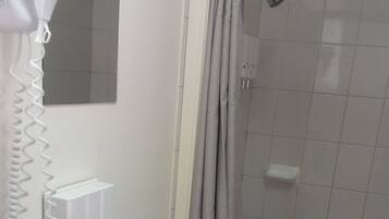 A bathroom with a sink, hand soap dispenser, and a hairdryer.