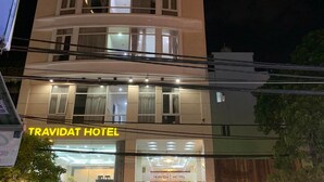 A multi-story hotel with a prominent sign reading "TRAVIDAT HOTEL". - Dattravi Hostel (Da Nang)