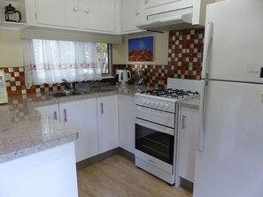 Cabin 2 - Green (External Bathroom) | Private kitchen - Lake Eacham Tourist Park & Self Contained Cabins (Lake Eacham)