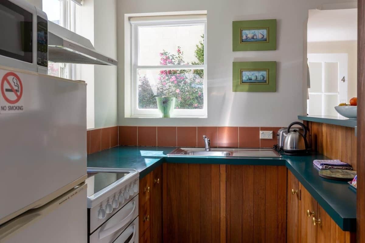 apartment, balcony, hill view | private kitchen | full-sized fridge, microwave, stovetop, coffee/tea maker