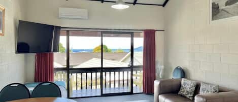 Lake View Two-bedroom Apartment | Living area | Flat-screen TV