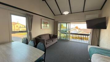 Apartment with Lake view | Living area | Flat-screen TV
