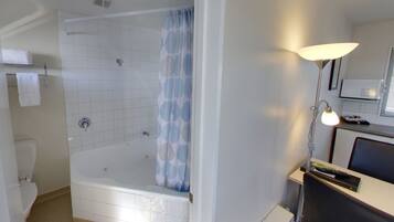 A bathroom with a bathtub, a shower, a toilet, and a sink.