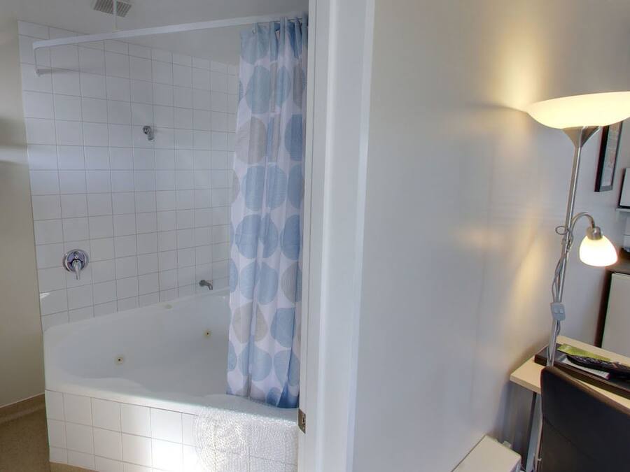 A bathroom with a bathtub, a shower, a toilet, and a sink.